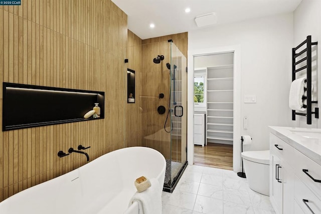 full bathroom featuring vanity, separate shower and tub, and toilet