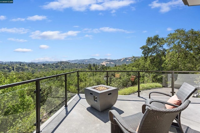 balcony featuring a mountain view and a fire pit