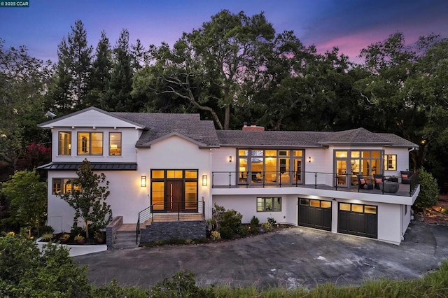 view of front of home featuring a balcony and a garage