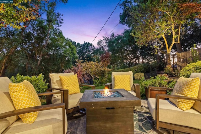 patio terrace at dusk featuring a fire pit