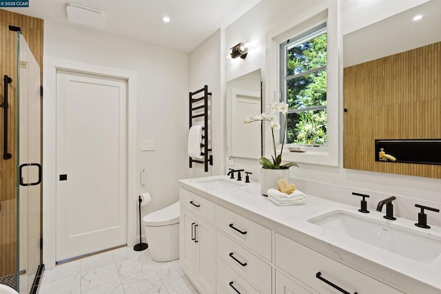 bathroom with walk in shower, vanity, and toilet