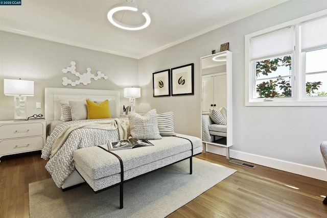 bedroom featuring crown molding and hardwood / wood-style floors