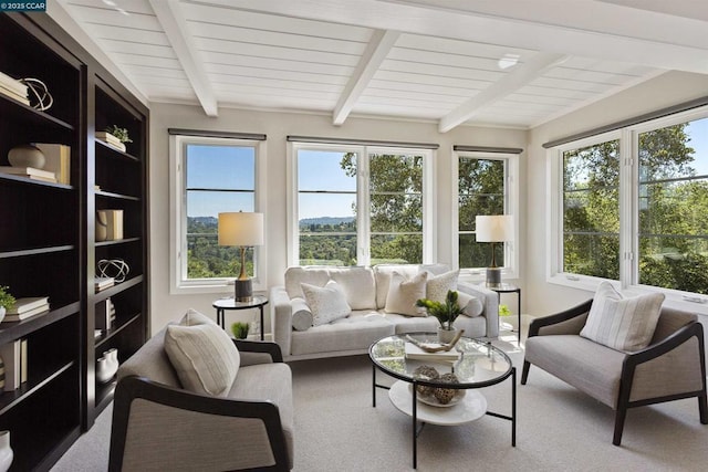 sunroom / solarium with a healthy amount of sunlight and beam ceiling