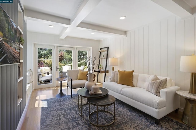 living room with coffered ceiling, beam ceiling, wooden walls, and hardwood / wood-style flooring