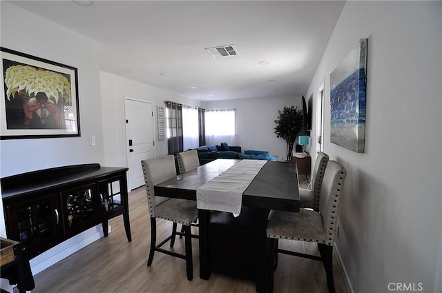 dining area with hardwood / wood-style flooring