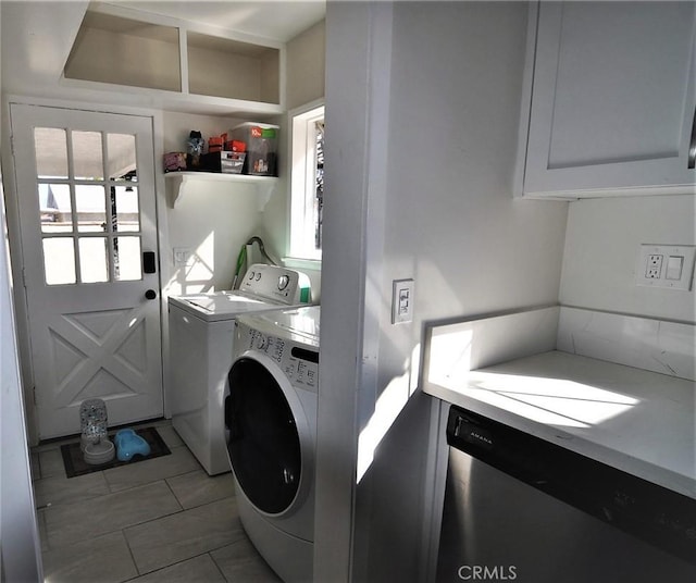 clothes washing area with separate washer and dryer and light tile patterned floors