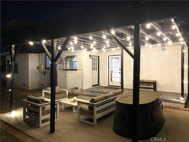 patio at twilight with an outdoor living space and a pergola