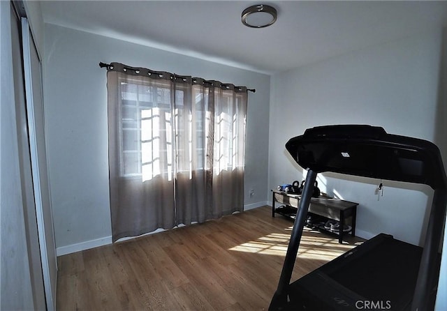 workout area with hardwood / wood-style floors