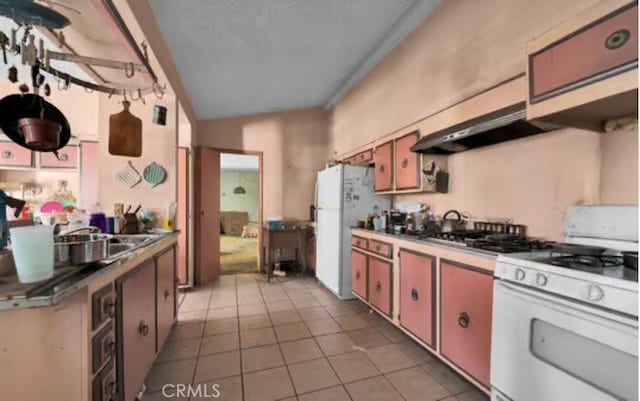 kitchen with extractor fan, white appliances, and light tile patterned flooring