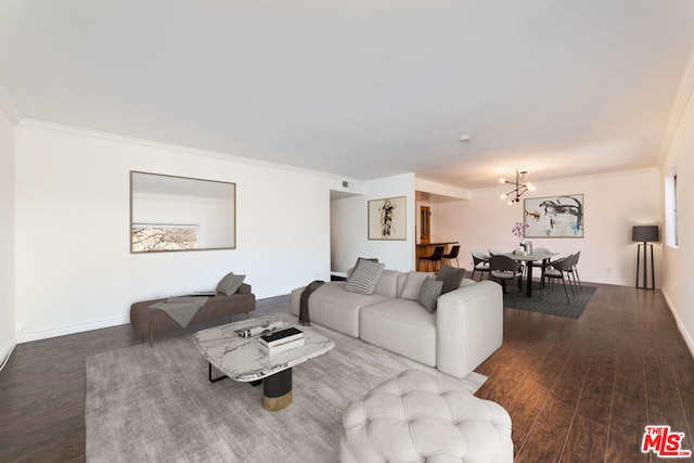 living room with dark hardwood / wood-style flooring, crown molding, and a chandelier