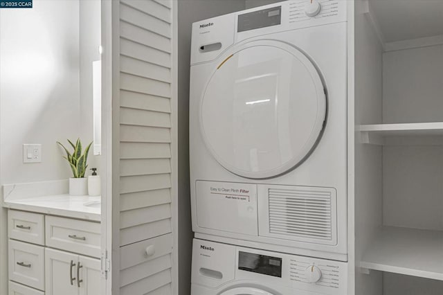 laundry area featuring stacked washer and dryer