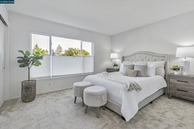 bedroom featuring crown molding and light colored carpet