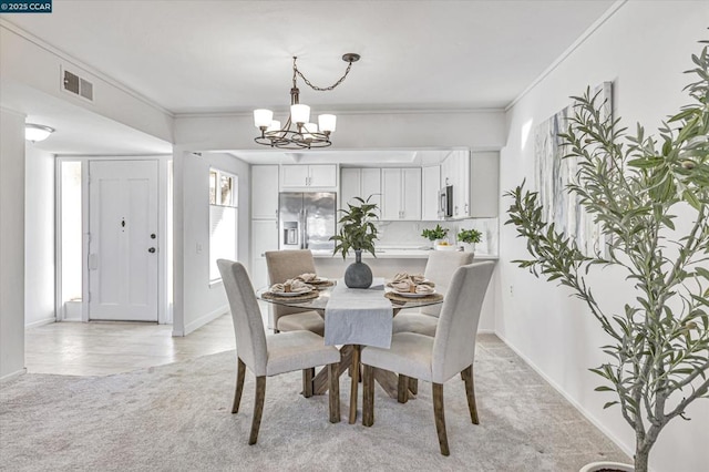 dining space featuring crown molding, light colored carpet, and a notable chandelier