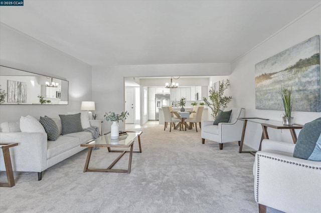 living room with an inviting chandelier and light colored carpet