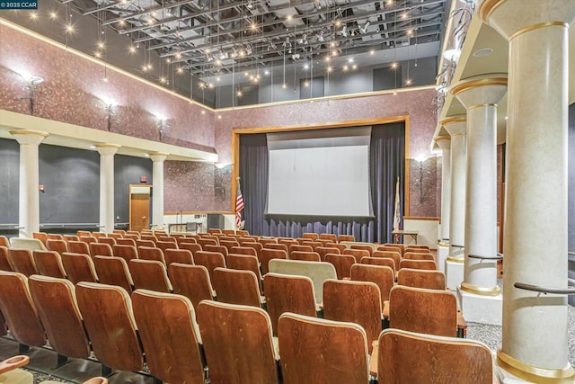 cinema room with a high ceiling and ornate columns