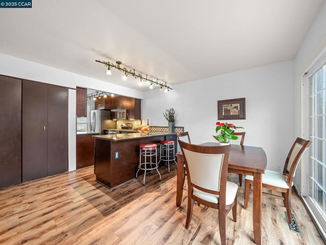 dining area featuring light wood-type flooring