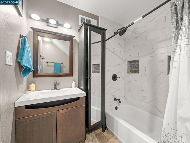 bathroom featuring vanity, hardwood / wood-style floors, and shower / tub combo with curtain