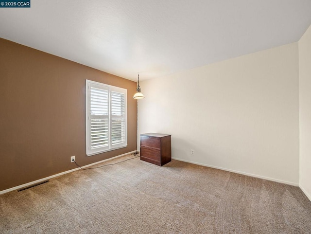 empty room featuring light colored carpet