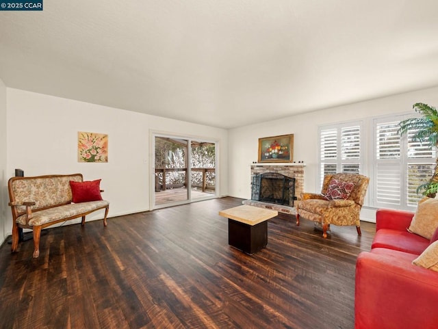 living room with a baseboard radiator, dark wood-type flooring, and a fireplace