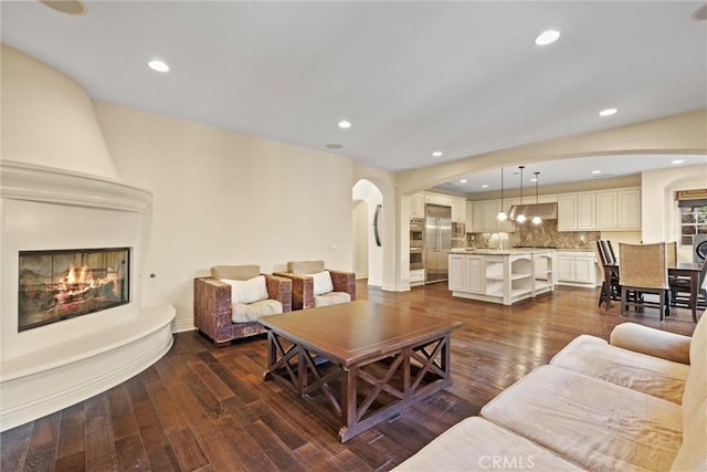 37 Triple Leaf, Irvine, CA 92620 - living room with arched walkways, a fireplace, dark wood-style floors, and recessed lighting