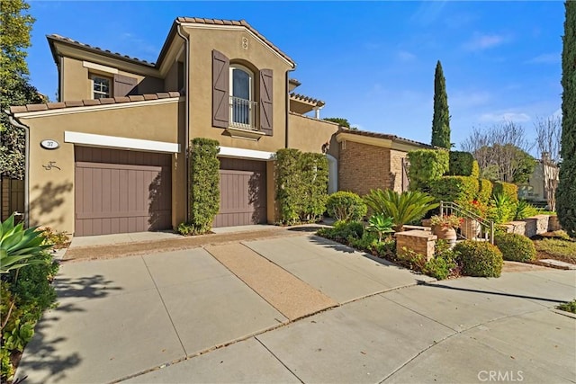 37 Triple Leaf, Irvine, CA 92620 - mediterranean / spanish house featuring an attached garage, stucco siding, concrete driveway, and a tile roof