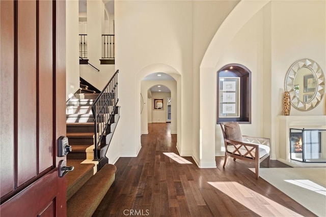 37 Triple Leaf, Irvine, CA 92620 - entrance foyer featuring dark wood-type flooring, a high ceiling, arched walkways, stairs, and baseboards