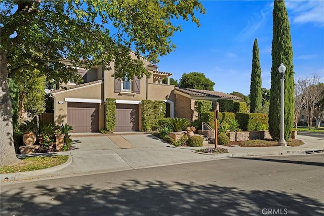 37 Triple Leaf, Irvine, CA 92620 - view of front of home featuring an attached garage, driveway, stucco siding, and a balcony