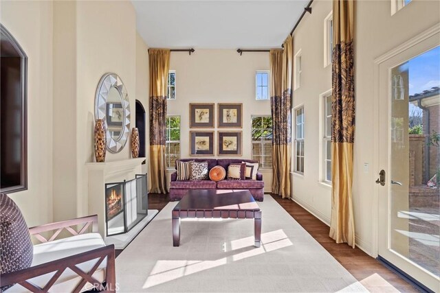 37 Triple Leaf, Irvine, CA 92620 - living area with wood finished floors, healthy amount of natural light, a high ceiling, a lit fireplace, and arched walkways