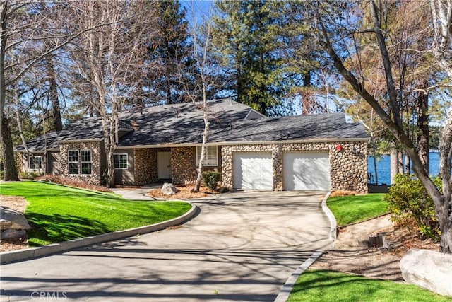 ranch-style house with a water view, a garage, and a front yard