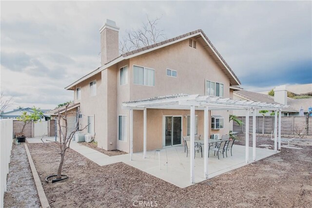 rear view of house featuring a pergola