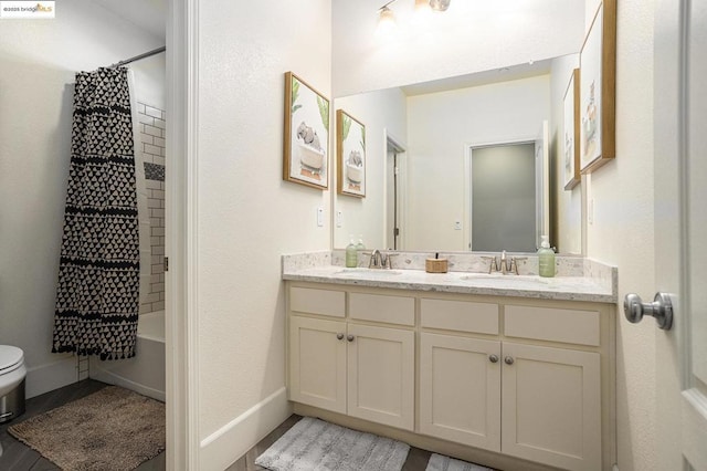 full bathroom featuring vanity, shower / tub combo, and toilet