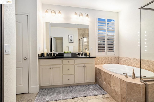 bathroom featuring shower with separate bathtub and vanity