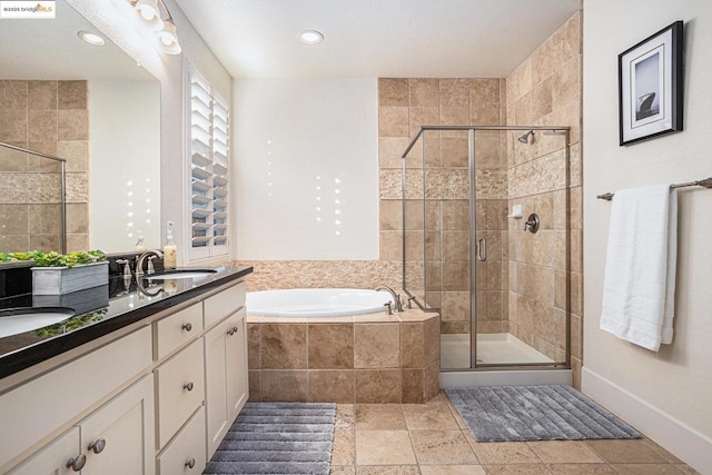 bathroom with vanity and separate shower and tub