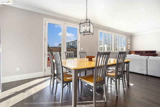 dining space featuring dark wood-type flooring and ornamental molding