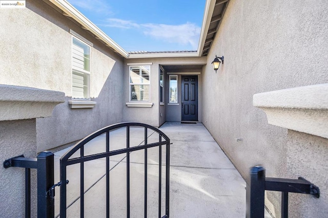 view of exterior entry featuring a patio