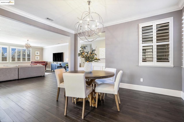 dining room with dark hardwood / wood-style flooring, crown molding, and a chandelier