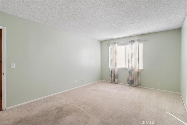 unfurnished room with a textured ceiling and carpet flooring