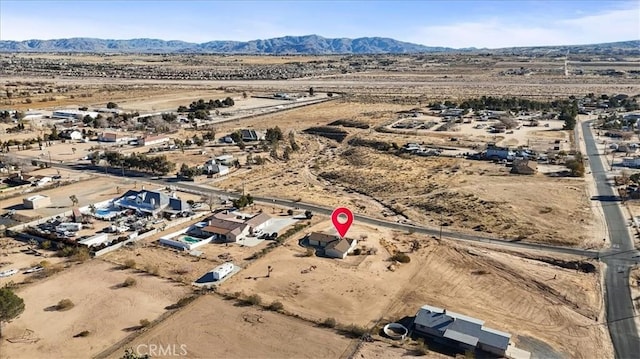 birds eye view of property featuring a mountain view