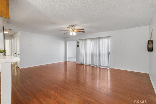 unfurnished living room featuring wood-type flooring, a textured ceiling, and ceiling fan