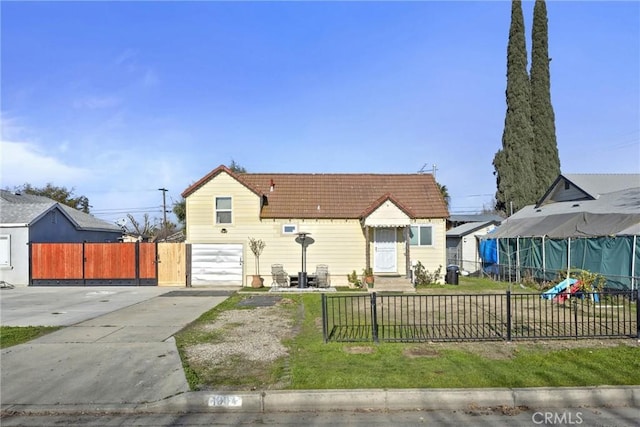 bungalow-style house with a garage and a front yard