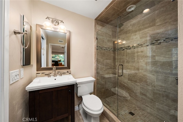 bathroom with tasteful backsplash, vanity, a shower with door, and toilet