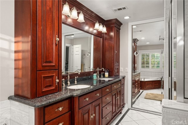 bathroom featuring tile patterned flooring, vanity, and a bathtub