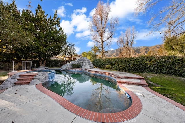 view of swimming pool with a mountain view