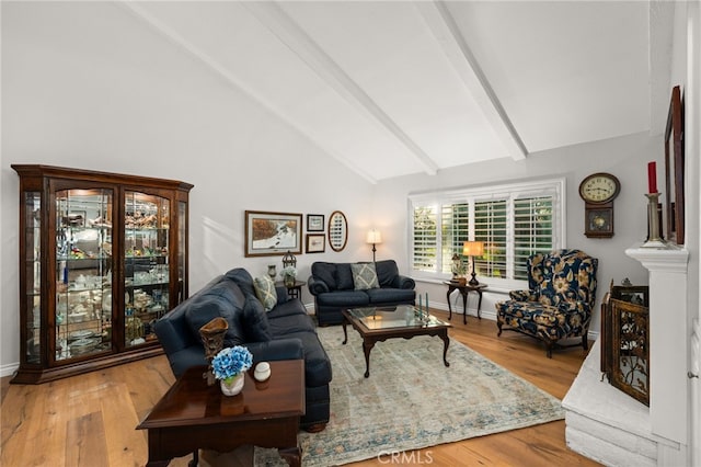 living room with lofted ceiling with beams and wood-type flooring