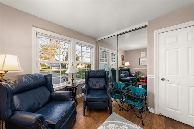 sitting room with dark hardwood / wood-style flooring