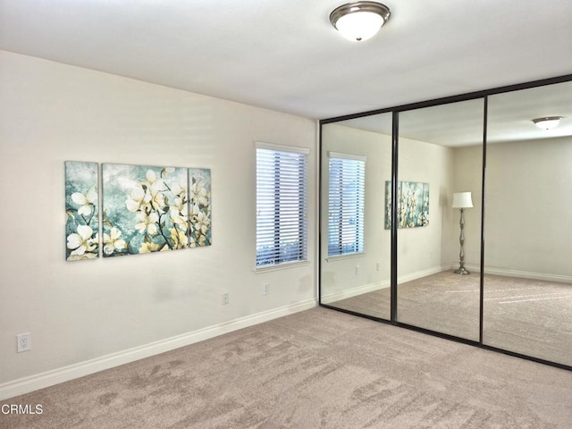 unfurnished bedroom featuring carpet and a closet