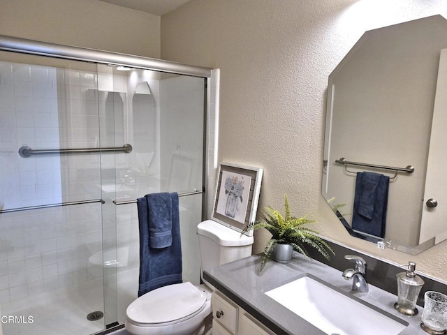 bathroom featuring vanity, toilet, and walk in shower