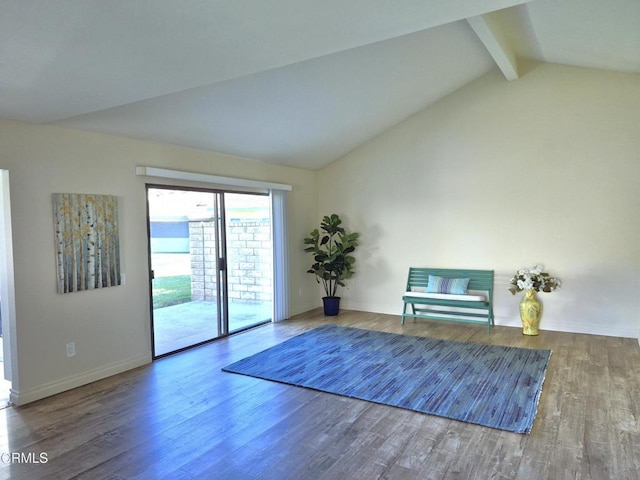 unfurnished room with vaulted ceiling with beams and wood-type flooring