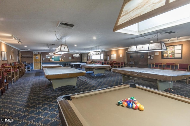 playroom with dark carpet, pool table, and ornamental molding