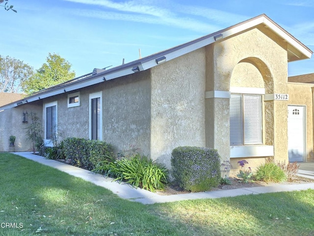 view of side of home featuring a yard